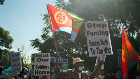 Getty Images Eritreans living in South Africa protest at the Eritrean embassy in Pretoria demanding that Eritrean soldiers withdraw from Ethiopia's Tigray region - May 2021