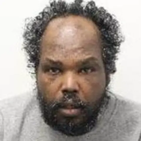 Metropolitan Police A police custody image of Ahmed Sheiki Ahmed. He is wearing a grey sweater. 