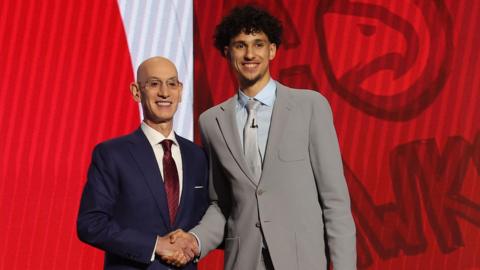 Zaccharie Risacher poses with NBA commissioner Adam Silver after being selected first overall by the Atlanta Hawks in the 2024 NBA Draft