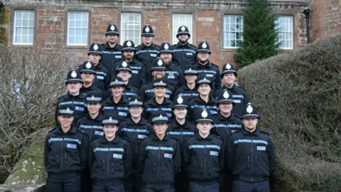 Cumbria Police Rows of recruits in front of the force headquarters 