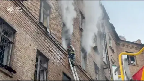 DSNS Ukraine A firefighter works at the site of a Russian attack, amid Russia's attack on Ukraine, in a location given as Kyiv, Ukraine,