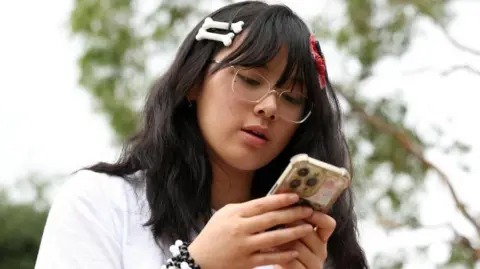 Annie Wang, 14, poses after an interview discussing Australia’s social media ban for users under 16