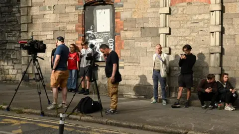 Reuters Members of the media wait outside the Special Criminal Court where alleged Irish crime gang boss Daniel Kinahan is due to appear on charges of organised criminal activity after being extradited to Ireland from the United Arab Emirates