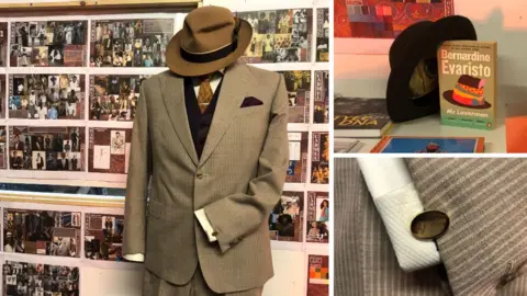 The suit jacket, shirt and hat worn by Lennie James for Mr Loverman along with close-up images of a cufflink and his hat