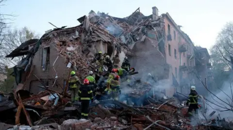 Rescue workers searching the ruins of a collapsed building in Ukraine 