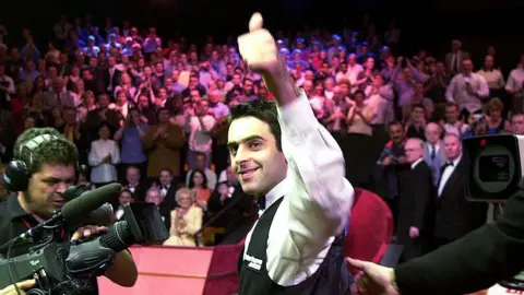 Ronnie O'Sullivan smiles and celebrates with a thumbs-up gesture after winning the 2001 World Championship