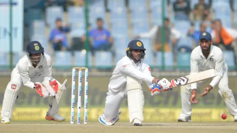 Sri Lanka's Dhananjaya de Silva plays a reverse sweep shot in a Test against India in 2017