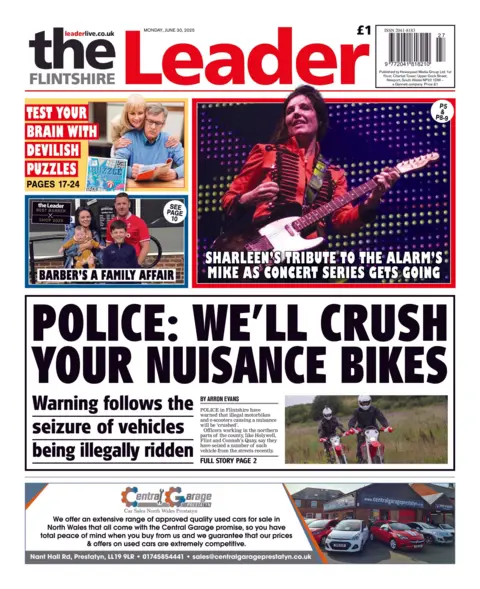 Flintshire Leader The Flintshire Leader newspaper front page shows main headline next to a photo of two people on motorbikes wearing helmets: 'Police: We'll crush your nuisance bikes'. Other headlines on the front page are: 'Sharleen's tribute to the Alarm's Mike as concert series gets along' and 'Barber's a family affair'.