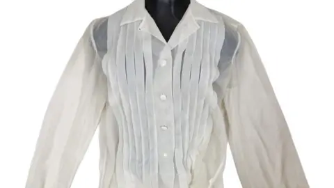 A image of a delicate white blouse that belonged to the actress Marilyn Monroe