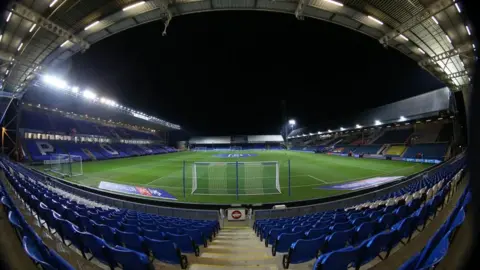 PA Media Empty blue chairs in the stand at Peterborough United's Weston Homes Stadium