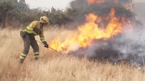 Firefighter battles wildfire