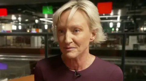 BBC Ruth Dodsworth in BBC newsroom speaking to a reporter