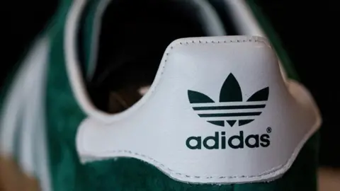 A green Adidas Gazelle trainer for sale at a shop in Berlin, Germany on 2 May. 2024.