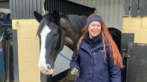 Photograph of Tracy Ellison from Wigan. The 48 year-old is pictured with her horse at a stables in Hindley Green.