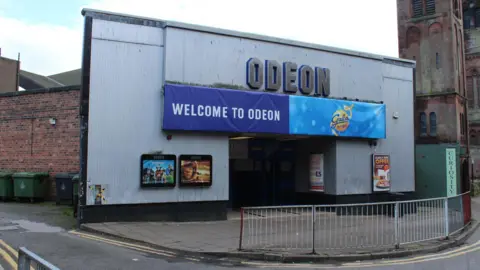 Billy McCrorie/ Geograph A photo of the exterior of the cinema, taken in 2015. There is a large Odeon sign, above a banner saying 'Welcome to Odeon'