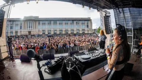 Crowds watching a DJ perform at Lloyds Amphitheatre in Bristol at Harbour Festival 2024