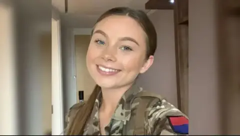Family photo Young woman in a military outfit smiling in a selfie-style photo
