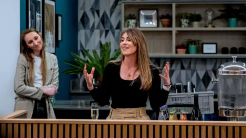 Kamila Jarczak This Ends Now director Sydney-Anne McAllister is stood in what looks like a cafe giving a speech.