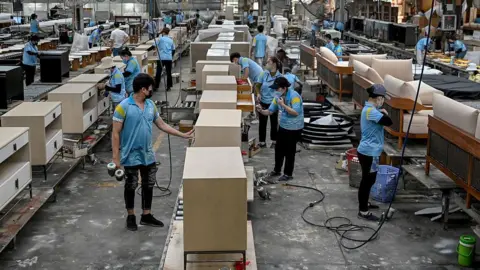 Getty Images This photo taken on November 4, 2025 shows employees assembling furniture inside the Jonathan Charles Fine Furniture factory in Ho Chi Minh City.