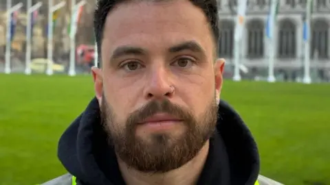 Dom Edington outside Parliament