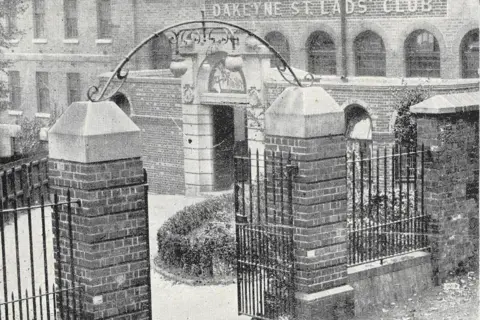 Dakeyne Farm Vintage photograph showing two brick pillars forming the entrance to a building which has a sign saying Dakeyne Street Lads Club