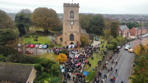 Eleanor Lang People gathered outside of Saint Mary's Church in Bulwell.