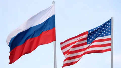 File image of the Russian and American flags flying side-by-side