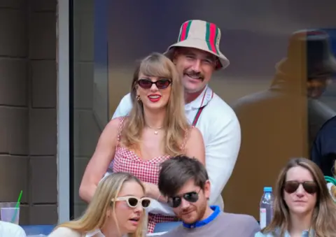 Getty Images Travis Kelce cuddles Taylor Swift
