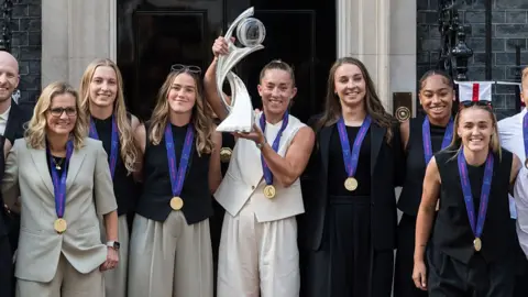 Getty Images England Women's National Football Team, the Lionesses, pose with the Euro 2025 trophy outside Downing Street in London on 28 July 2025. 