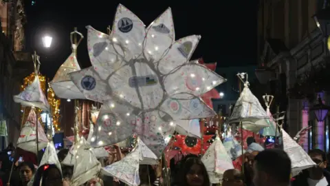 West Northamptonshire Council Home-made laterns and decorations are taken along Northampton's streets in the dark during Diwali celebrations on 26 October 2024.