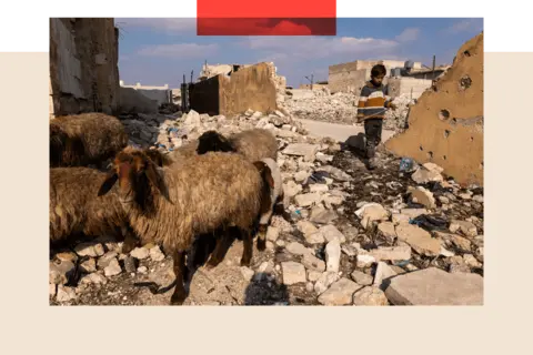 Getty Images A child walks through rubble from in Aleppo, Syria on January 25, 2025 