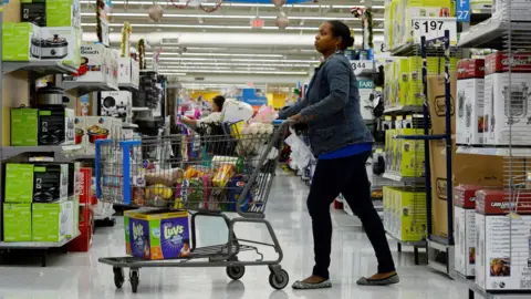 Reuters A woman pushes a trolley through a Walmart supermarket