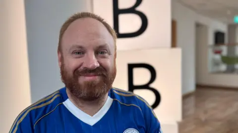 Eli Drury before the shave with a bushy ginger beard on his face