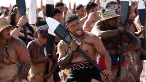 Getty Images Māori Warriors perform a haka on the beach at Waitangi during a service to commemorate the national holiday