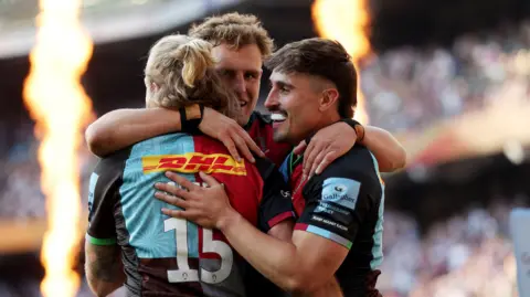 Cadan Murley (right) is congratulated by Harlequins team-mates Tyrone Green and Oscar Beard (centre) for one of his tries at Allianz Stadium 
