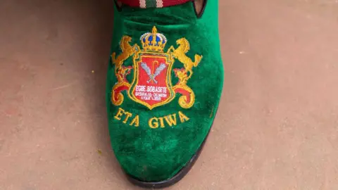 Toyin Adedokun/AFP A general view of a customised shoe worn by members of the Egbe Bobasete during the annual Ojude Oba festival in Ijebu Ode on June 18, 2024. Ojude Oba festival is an ancient festival celebrated by the Yoruba people of Ijebu Ode, a town in Ogun State Nigeria. This annual festival usually takes place the third day after Eid El Kabir to pay homage and show respect to the King the Awujale of Ijebuland. (Photo by TOYIN ADEDOKUN / AFP) 