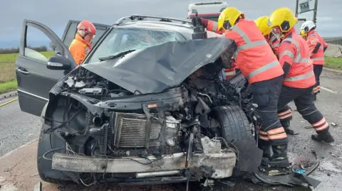 Firefighters at the scene of the crash