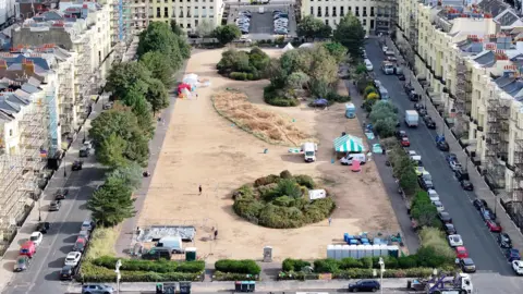 Eddie Mitchell Brunswick Square in Hove, which has a yellow and dry lawn.