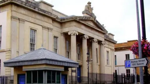 BBC Bishop Street courthouse with a parking sign outside 