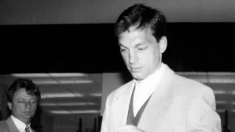 TIBOR ILLYES/MTI/AFP A black and white picture of a man in a white suit