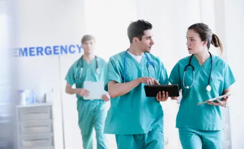 doctors talking in hospital emergency room - stock photo