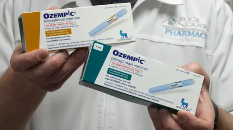 Reuters A pharmacist displays boxes of Ozempic, a semaglutide injection drug used for treating type 2 diabetes