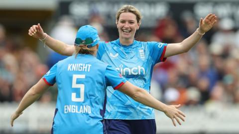 England's Lauren Bell and Heather Knight celebrate a wicket in the third one-day international against New Zealand