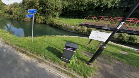 Google A Google Street image of a grass bank on the side of a canal.