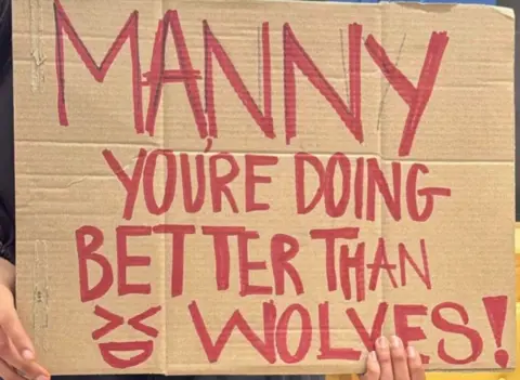 Manny Singh Kang A banner includes the words Manny you're doing better than Wolves. 