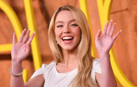 Getty Images Sydney Sweeney waving at the premiere