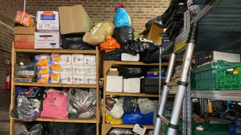 The storage room at the site packed with tinned food, toiletries and clothing