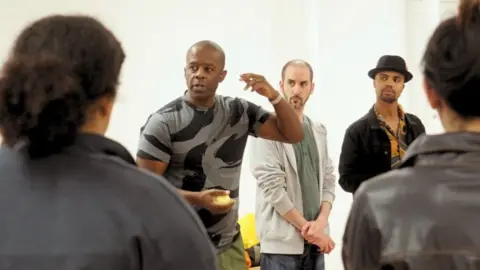 SCRUM Theatre Adrian Lester leading a workshop with fellow artists standing around him