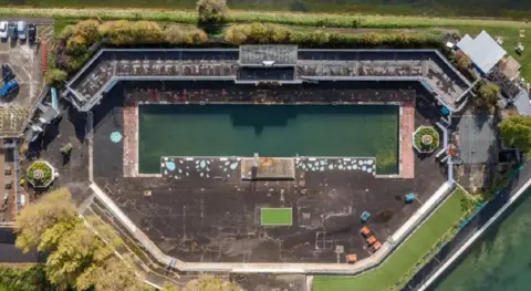 Portsmouth City Council Aerial view of Hilsea lido before its revamp - the site looks run down and the pool is full of murky water.