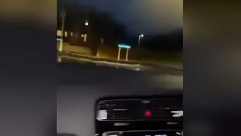A picture taken from inside the car looking out the front windscreen